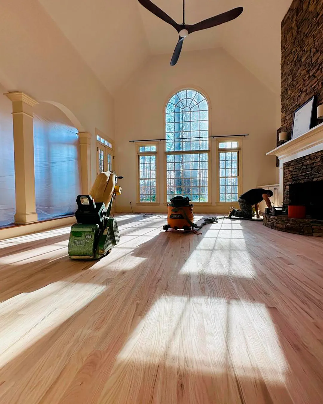 Refinished hardwood flooring in a fireplace room