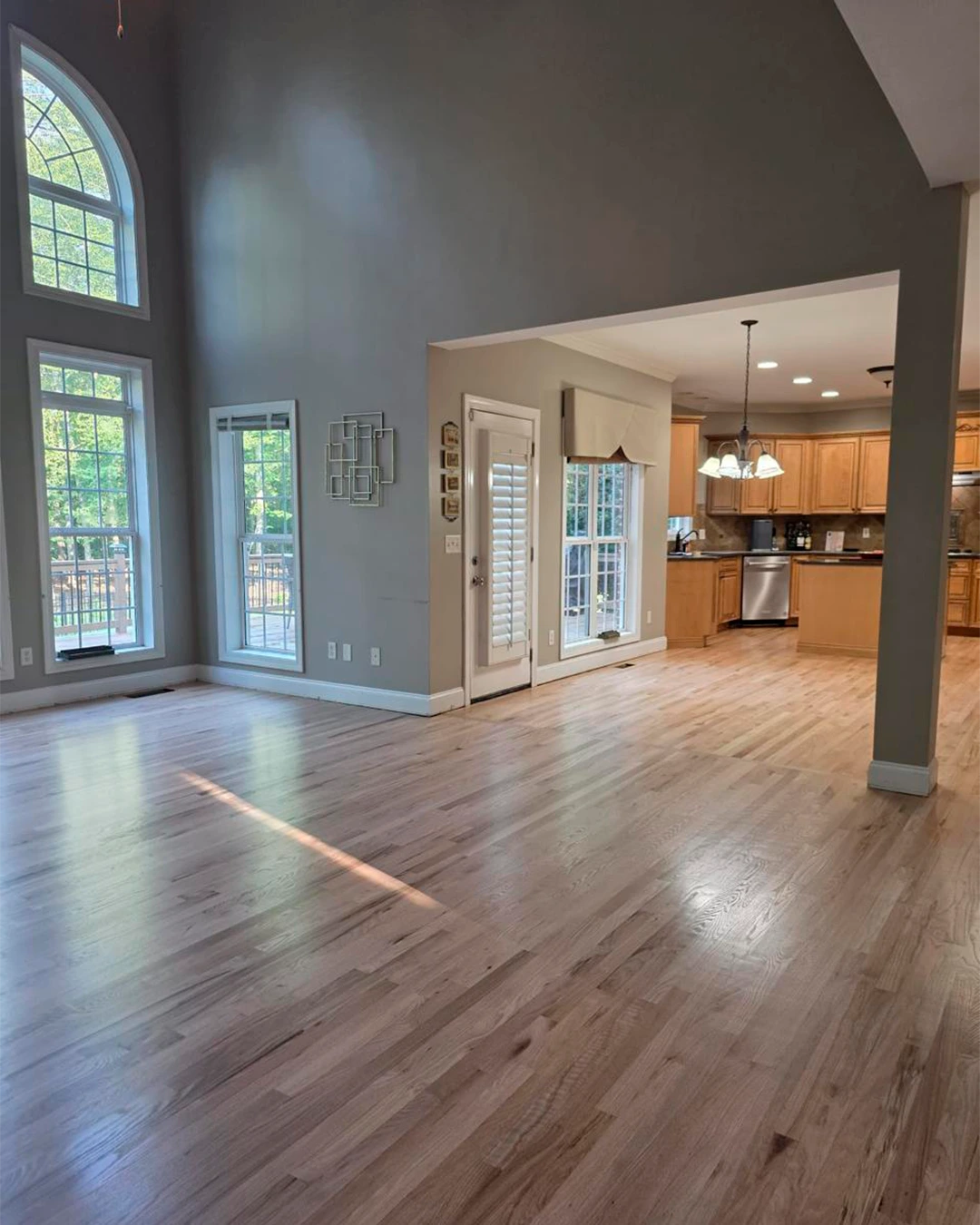 Hardwood flooring connecting a living room and kitchen